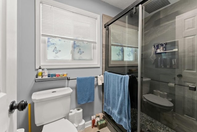1467 Hewatt Rd, Lilburn, GA 30047 - bathroom featuring toilet, a stall shower, plenty of natural light, and baseboards