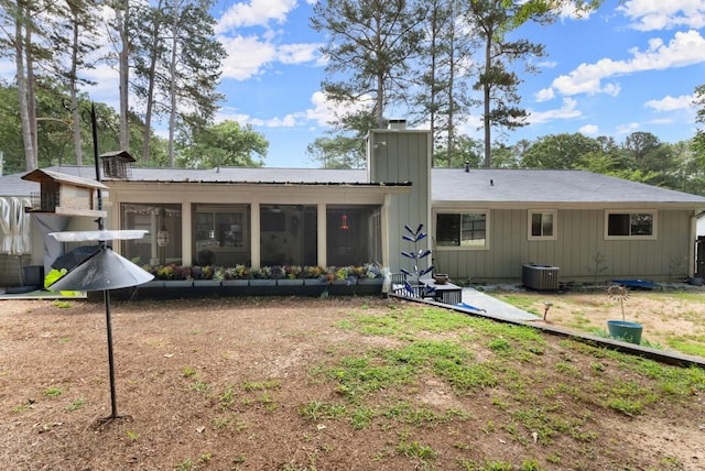 1467 Hewatt Rd, Lilburn, GA 30047 - back of property with a chimney, a sunroom, and central air condition unit