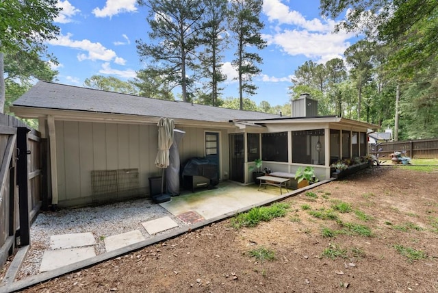 1467 Hewatt Rd, Lilburn, GA 30047 - back of house with a sunroom, a chimney, and a patio area