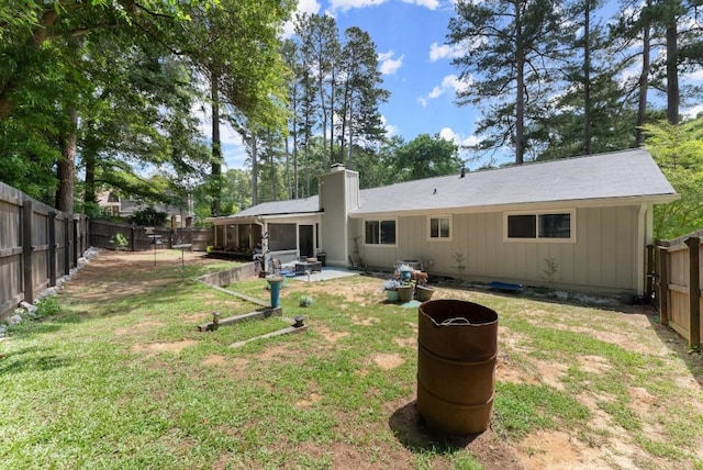 1467 Hewatt Rd, Lilburn, GA 30047 - rear view of property with a chimney and a patio area