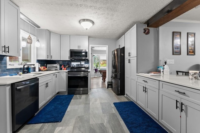 1467 Hewatt Rd, Lilburn, GA 30047 - kitchen featuring appliances with stainless steel finishes, a sink, tasteful backsplash, and light countertops