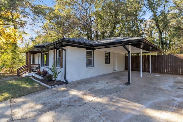 view of side of property featuring a carport