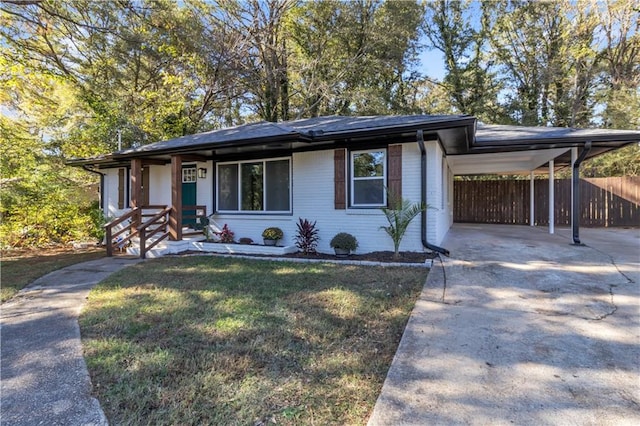 view of front of property featuring a front lawn and a carport