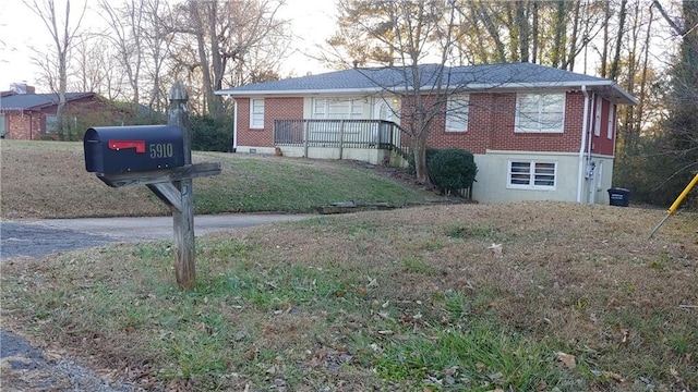 view of front of house featuring a front yard and a deck