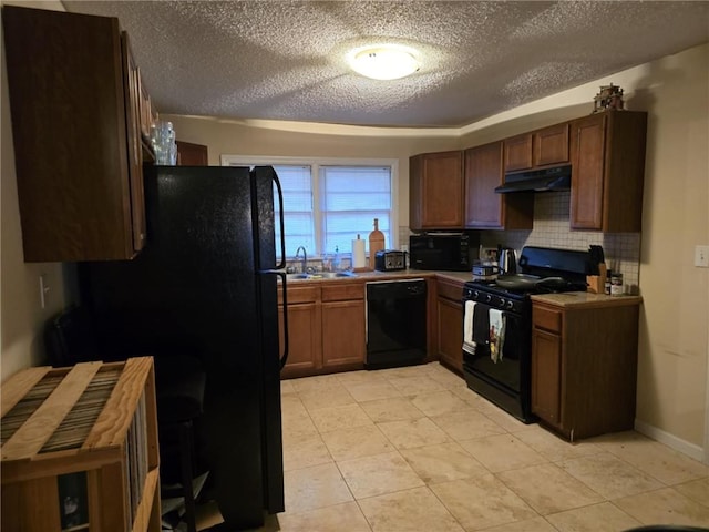 kitchen featuring sink, tasteful backsplash, a textured ceiling, light tile patterned floors, and black appliances