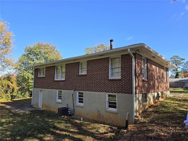 view of side of property featuring central AC