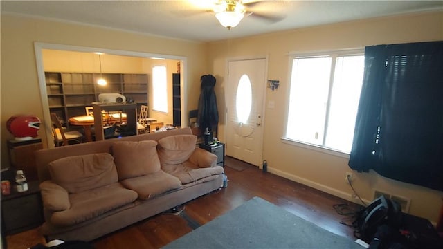 living room featuring dark hardwood / wood-style floors and ceiling fan