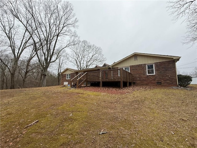 back of house with a yard and a deck