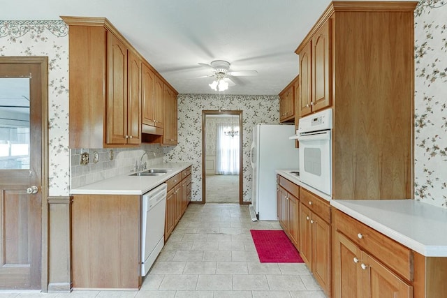 kitchen featuring white appliances, plenty of natural light, decorative backsplash, and sink