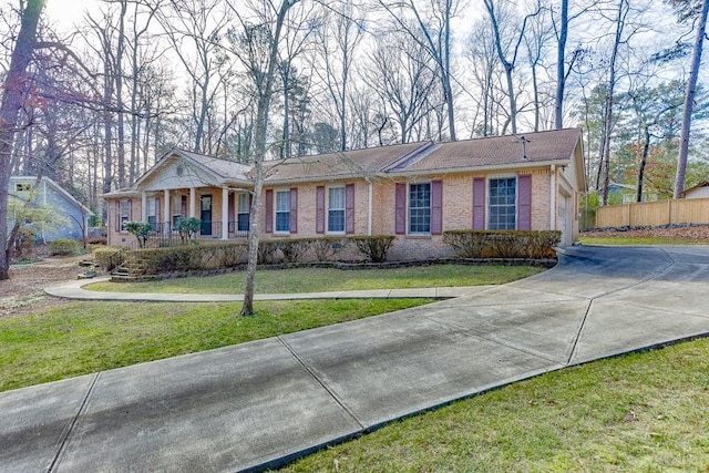 single story home with a porch and a front lawn