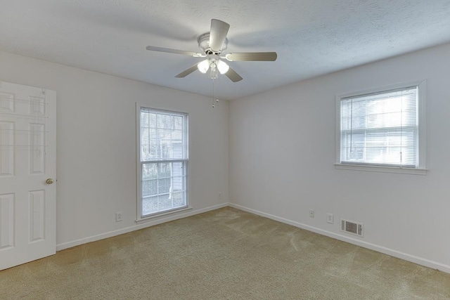 unfurnished room with ceiling fan and light carpet