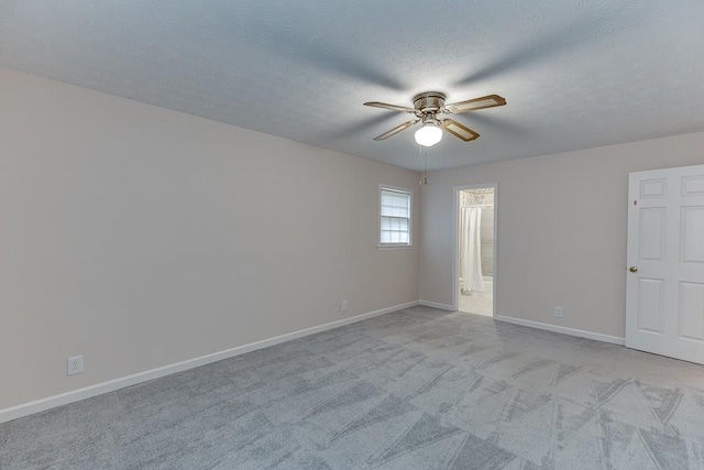 carpeted empty room featuring a textured ceiling and ceiling fan