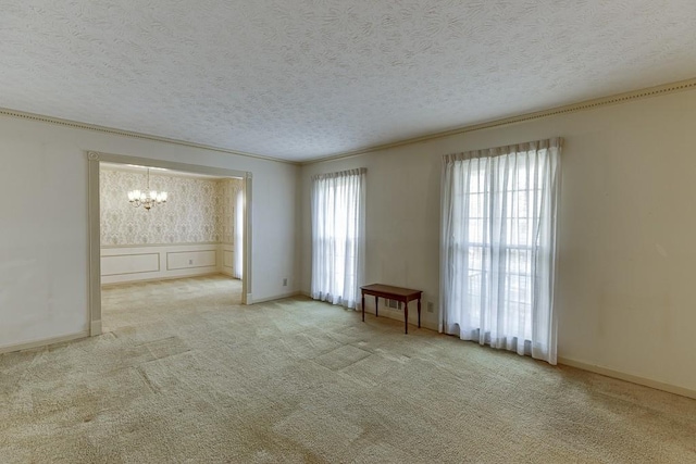 unfurnished room featuring a textured ceiling and light carpet