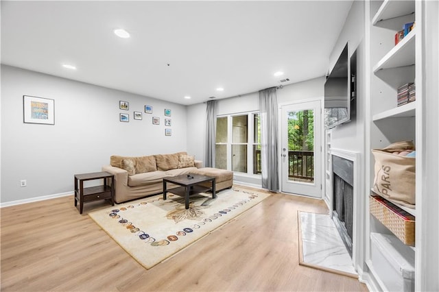 472 Sherman Way, Decatur, GA 30033 - living area with a fireplace, wood finished floors, recessed lighting, and baseboards