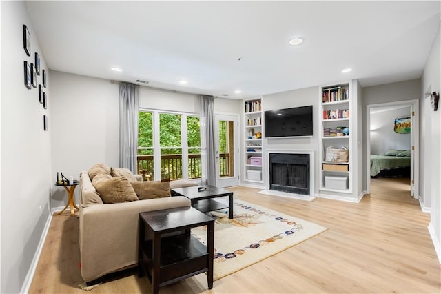 472 Sherman Way, Decatur, GA 30033 - living area featuring light wood-style floors, baseboards, a fireplace with flush hearth, recessed lighting, and built in features