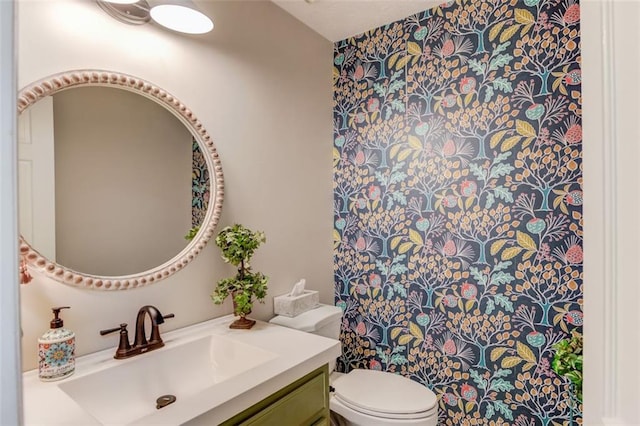 bathroom featuring toilet and vanity