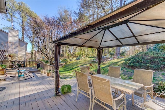 deck with outdoor dining area and a gazebo