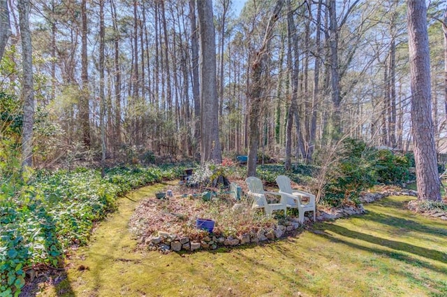 view of yard with a view of trees