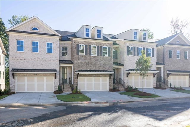 2260 Siskin Square Rd Unit 90, Duluth, GA 30096 - view of front of house featuring concrete driveway, a garage, a standing seam roof, and metal roof