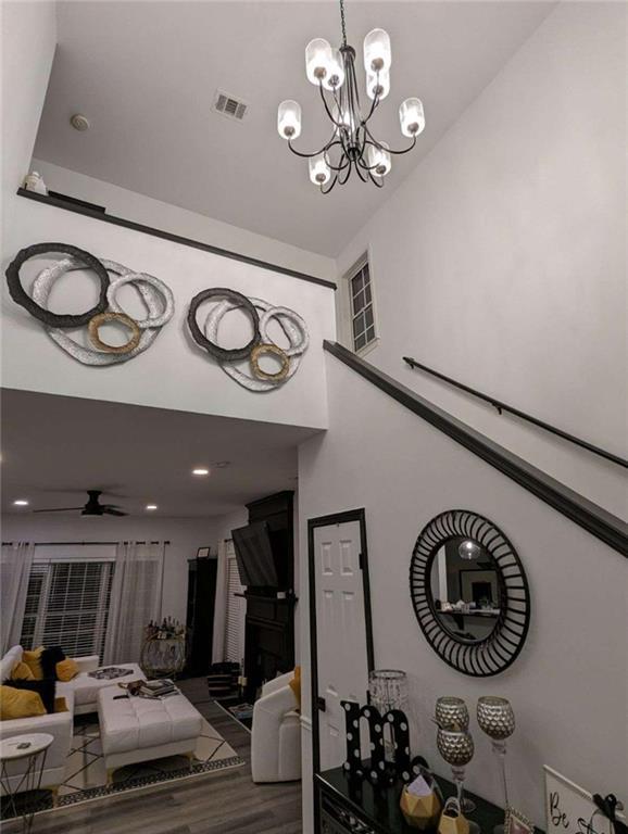 stairs with ceiling fan and wood-type flooring