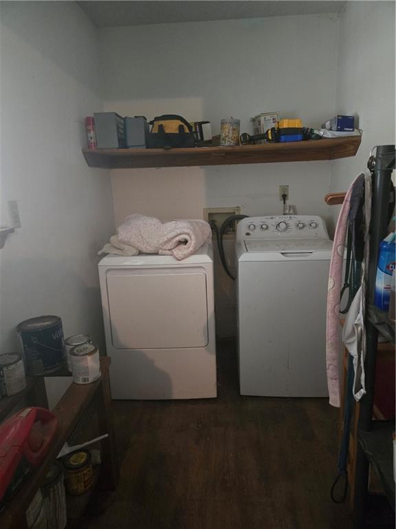 laundry room featuring washing machine and dryer and wood finished floors