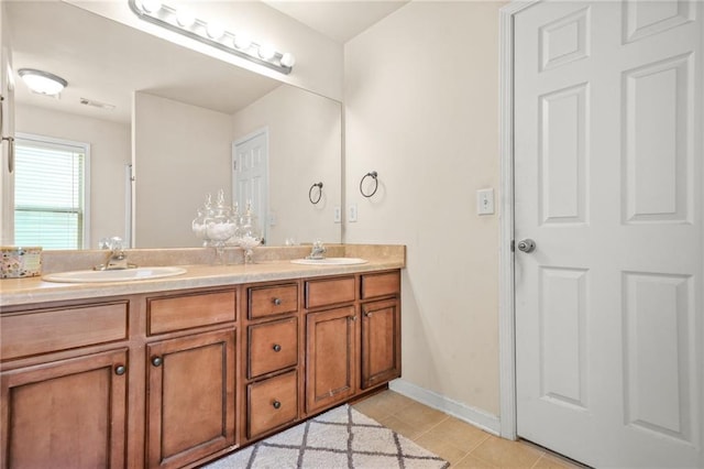 full bath featuring tile patterned flooring, double vanity, and baseboards