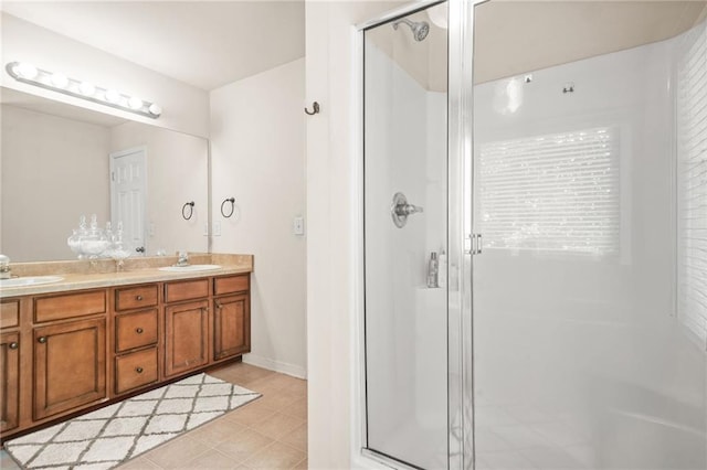 bathroom with a shower stall, double vanity, and tile patterned floors