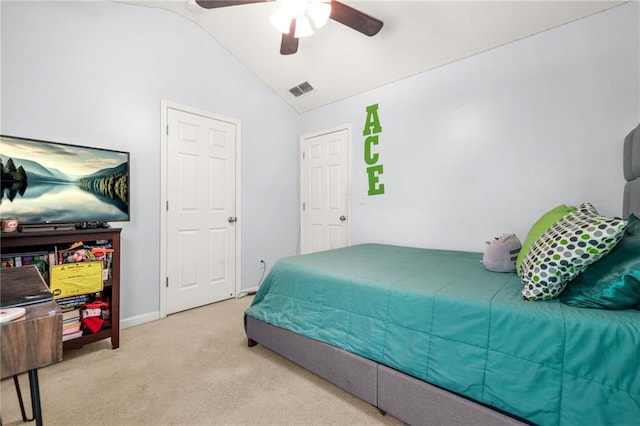 carpeted bedroom with vaulted ceiling, a ceiling fan, and baseboards