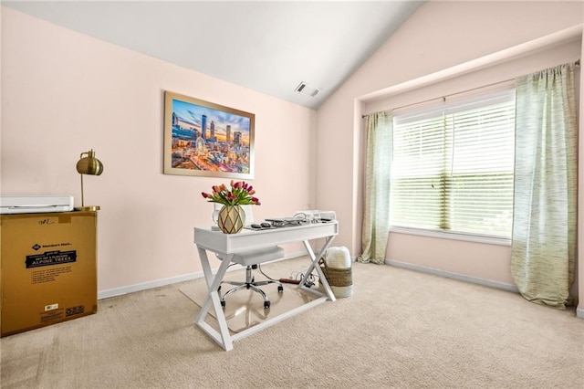 carpeted office featuring vaulted ceiling and baseboards