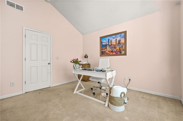 carpeted office space featuring lofted ceiling and baseboards