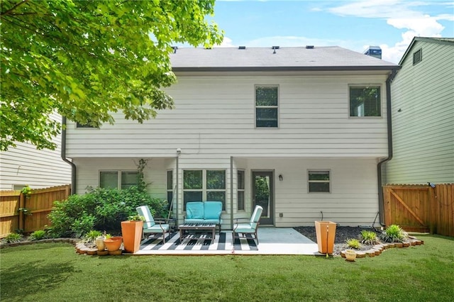 rear view of property featuring an outdoor living space, a patio, and a gate