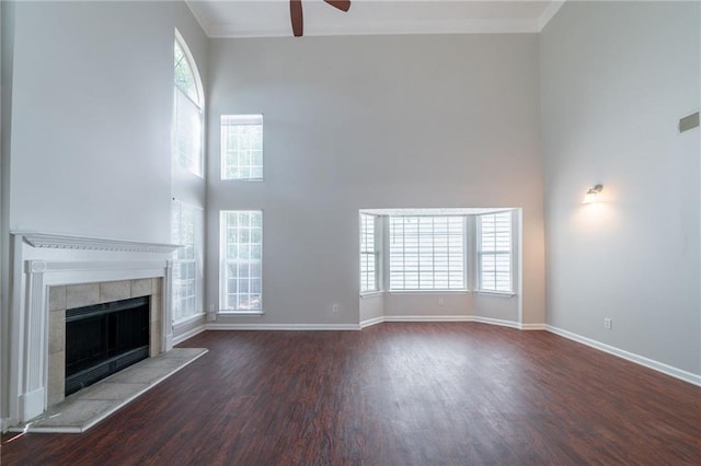 6509 Charter Way, Lithonia, GA 30058 - unfurnished living room featuring ceiling fan, wood finished floors, ornamental molding, a towering ceiling, and baseboards