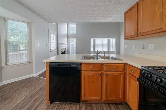 6509 Charter Way, Lithonia, GA 30058 - kitchen featuring black appliances, a sink, a peninsula, light countertops, and dark wood-style floors