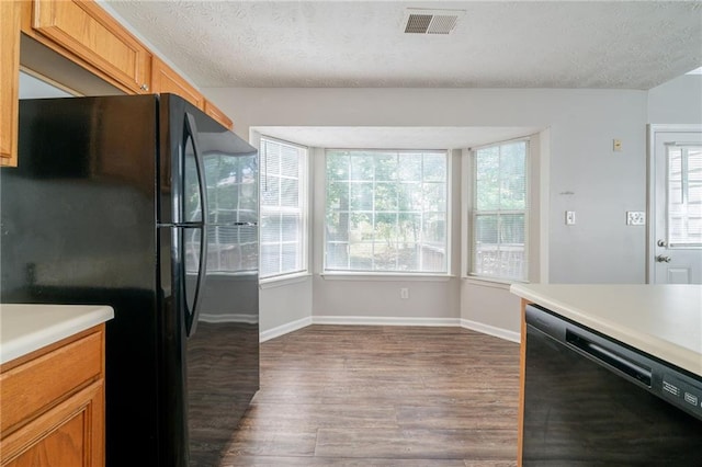 6509 Charter Way, Lithonia, GA 30058 - kitchen with black appliances, dark wood-style floors, plenty of natural light, light countertops, and a textured ceiling