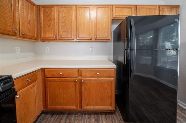 6509 Charter Way, Lithonia, GA 30058 - kitchen with freestanding refrigerator, light countertops, dark wood finished floors, and brown cabinetry