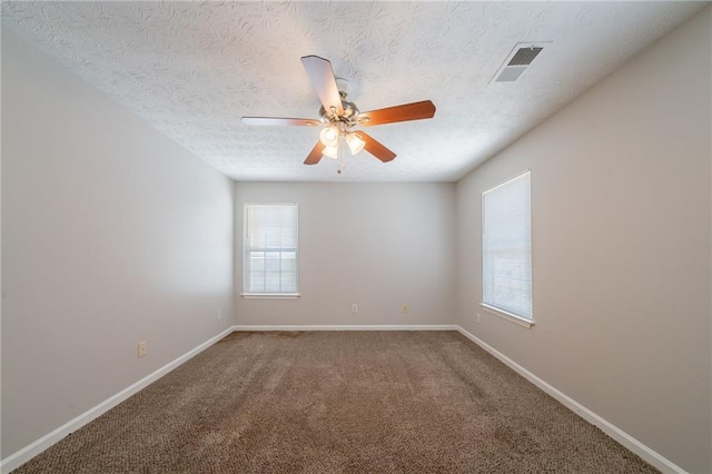 6509 Charter Way, Lithonia, GA 30058 - unfurnished room with healthy amount of natural light, baseboards, carpet floors, and a textured ceiling
