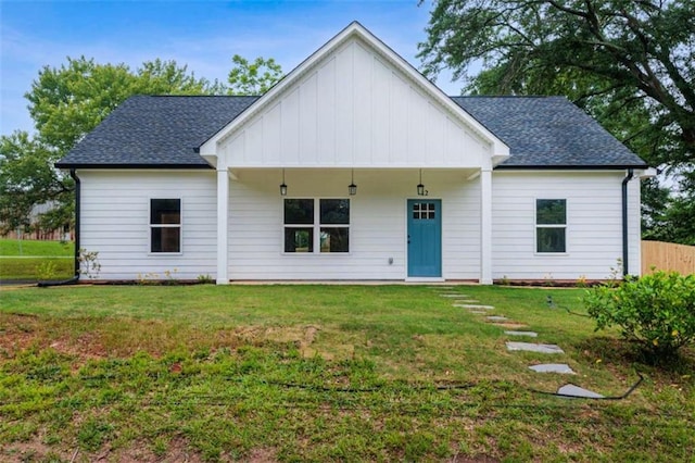 12 New St, Newnan, GA 30263 - view of front of house featuring board and batten siding, a front lawn, and roof with shingles