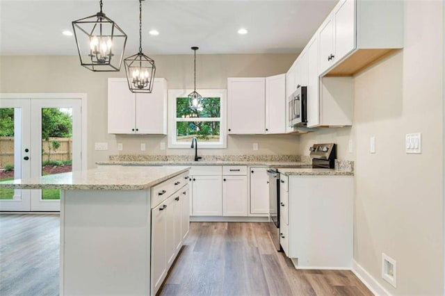 12 New St, Newnan, GA 30263 - kitchen with appliances with stainless steel finishes, plenty of natural light, light wood-type flooring, and recessed lighting