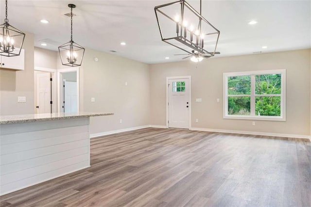 12 New St, Newnan, GA 30263 - unfurnished living room featuring a chandelier, wood finished floors, baseboards, and recessed lighting