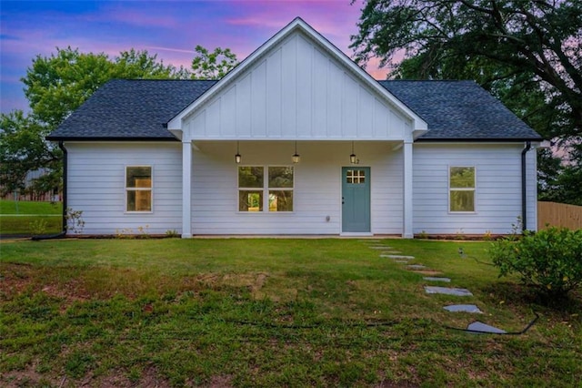 12 New St, Newnan, GA 30263 - view of front of home with board and batten siding, a lawn, and a shingled roof