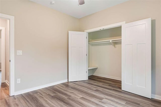 12 New St, Newnan, GA 30263 - unfurnished bedroom with wood finished floors, a closet, baseboards, and ceiling fan