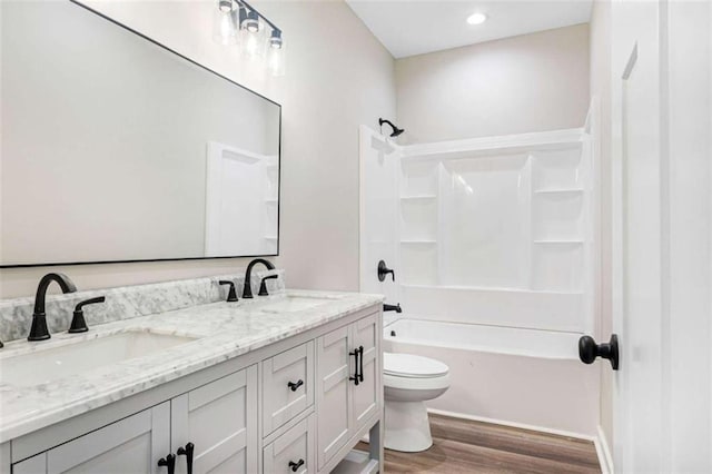 12 New St, Newnan, GA 30263 - bathroom with toilet, wood finished floors, double vanity, and shower / bathtub combination