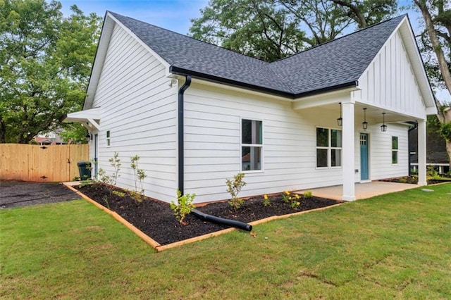 12 New St, Newnan, GA 30263 - view of side of property with board and batten siding, roof with shingles, a patio area, and a gate