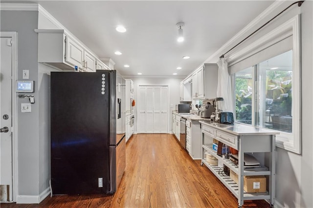 2900 Townley Cir, Atlanta, GA 30340 - kitchen with appliances with stainless steel finishes, light countertops, light wood-style flooring, crown molding, and baseboards