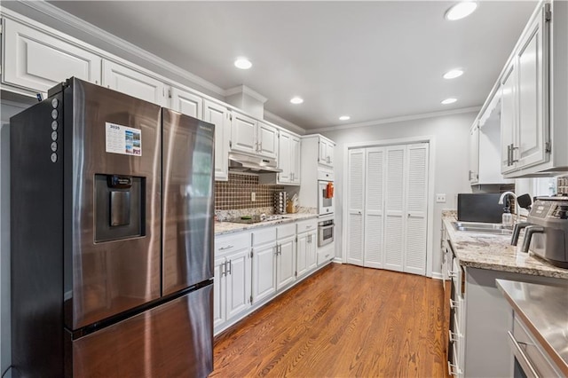 2900 Townley Cir, Atlanta, GA 30340 - kitchen with stainless steel refrigerator with ice dispenser, a sink, ornamental molding, decorative backsplash, and white cabinets