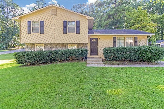 tri-level home with a front yard