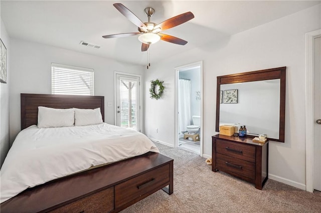 carpeted bedroom featuring ceiling fan and ensuite bath