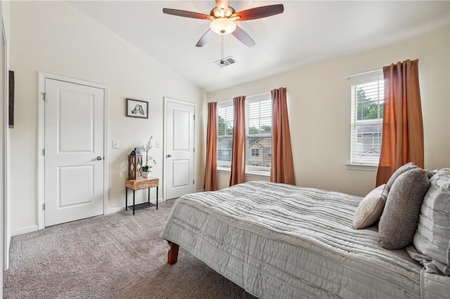 carpeted bedroom with ceiling fan and vaulted ceiling