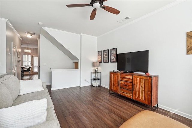 living room with ceiling fan with notable chandelier, crown molding, and dark hardwood / wood-style flooring