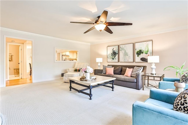 living room with light colored carpet, ornamental molding, and ceiling fan